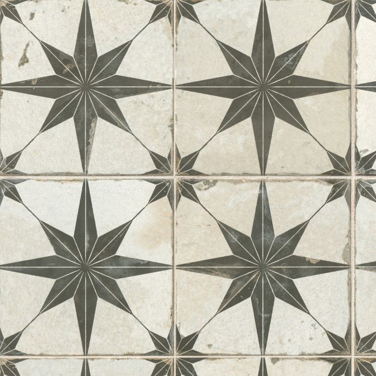 an old tile floor with black and white stars on it