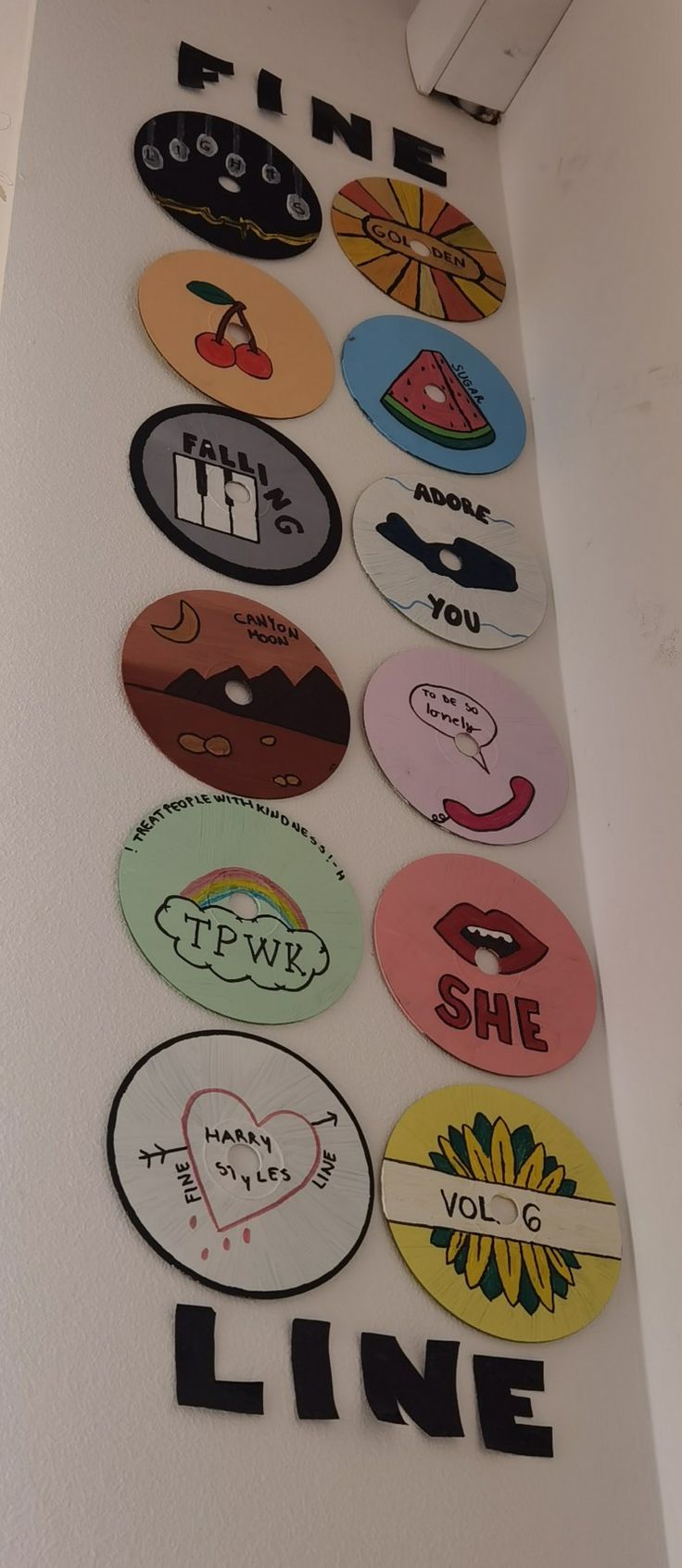 a wall with many different colored stickers on it's side and the word line written in black