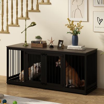 a dog is sitting in his kennel and watching the television screen while it's on