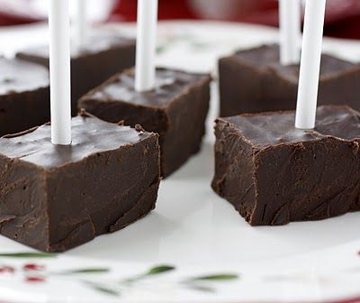 four pieces of chocolate on a plate with candles