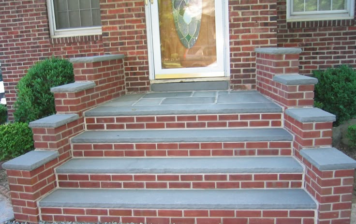 the steps are made out of bricks and cement to look like they have been placed in front of a door