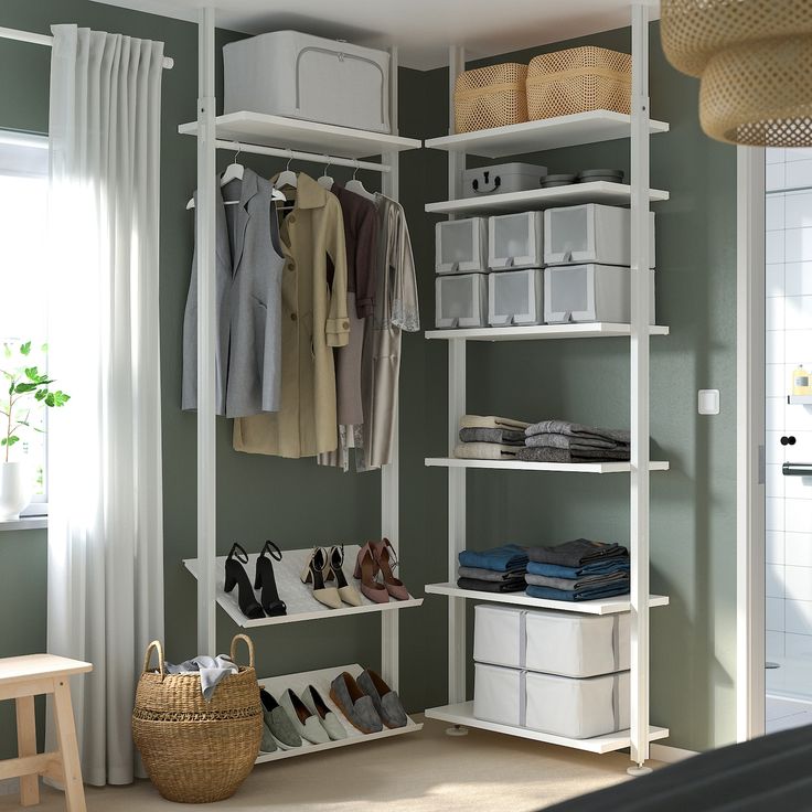 an organized closet with white shelves and baskets