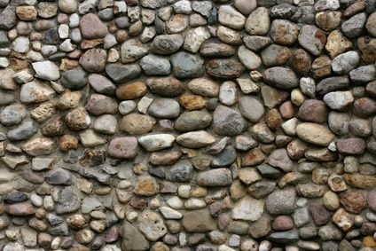 a stone wall with several rocks on it