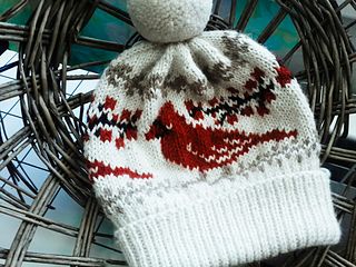 a knitted hat sitting on top of a wicker basket