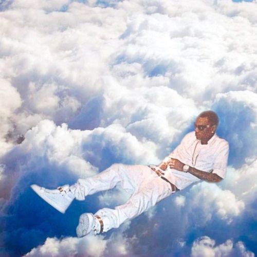 a man laying in the clouds with his feet up and hands on his hips as if he were floating