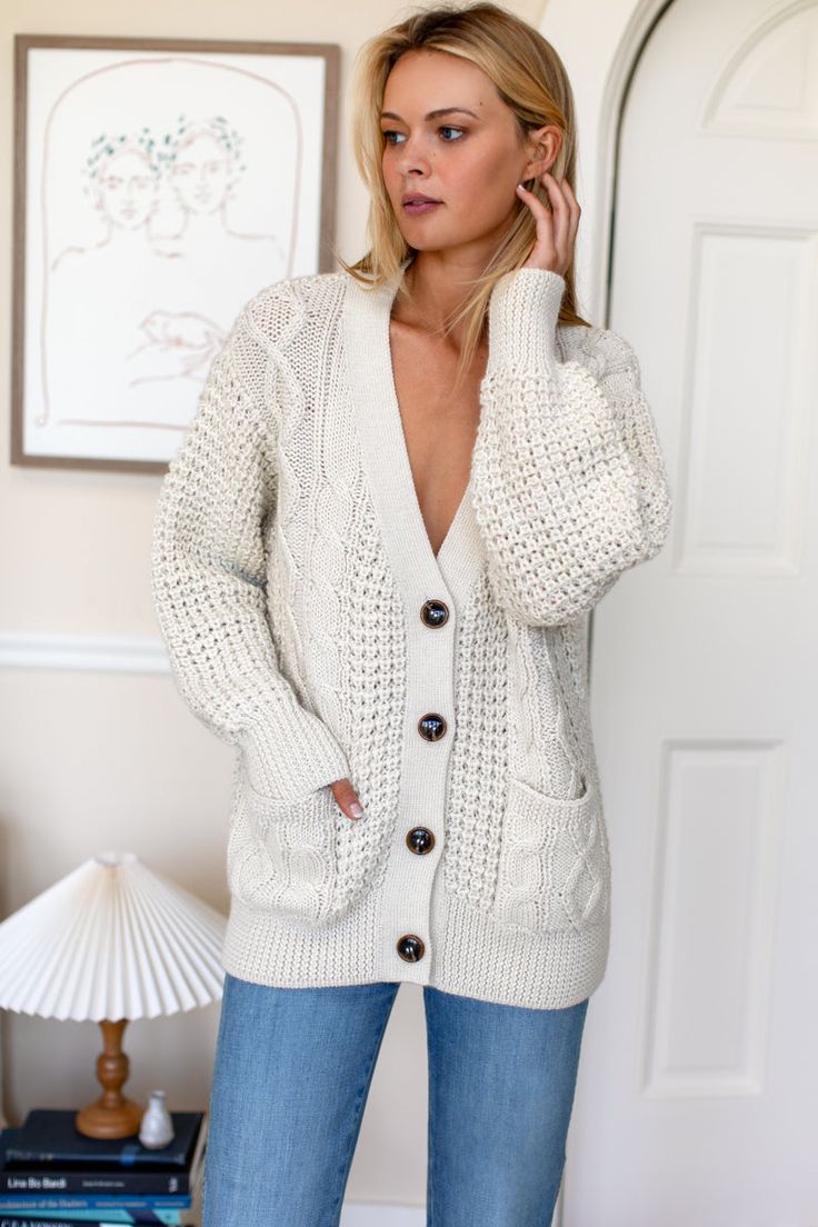 A luxe heirloom quality cardigan in the perfect, wear forever silhouette. Incredibly soft medium weight knit, jacket alternative, cozy layering. 100% super soft, extra fine alpaca Drop shoulder Patch pockets Model is wearing a size Small Dry clean Made in Peru XS: Bust 41”, Center back length 24 1/2"S: Bust 43”, Center back length 25"M: Bust 45”, Center back length 25 1/2"L: Bust 47”, Center back length 26" Soft Knit V-neck Outerwear, Cozy V-neck Outerwear For Everyday, V-neck Cable Knit Outerwear For Layering, Everyday Cream V-neck Outerwear, Winter White V-neck Outerwear For Layering, Wool Cable Knit Outerwear For Layering, Elegant Long Sleeve Cardigan With Soft Texture, Cozy Cream Cashmere Sweater, Soft Wool Sweater For Fall