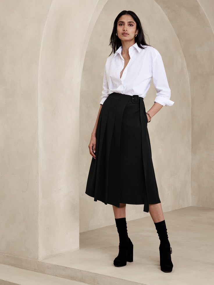 This midi skirt uses a pleated, asymmetrical front to inspire and is cut from a bonded twill fabric we love for its soft structure.  A-line fit.  Adjustable belt at wearer's left.  Side seam pockets.  Unlined.  A-line.  Midi length.  Model: Size 2, 5'10" (178cm). Asymmetrical Pleated Skirt For Work, Midi Length Skirt With Belt Loops, Fall Pleated Skirt With Belt Loops For Work, Fall Workwear Pleated Skirt With Belt Loops, Fall Workwear Skirt With Belt Loops, Elegant Asymmetrical Wrap Skirt For Work, Fitted Belted Pleated Skirt For Work, Workwear Skirt With Belt Loops And Relaxed Fit, Workwear Skirt With Belt Loops