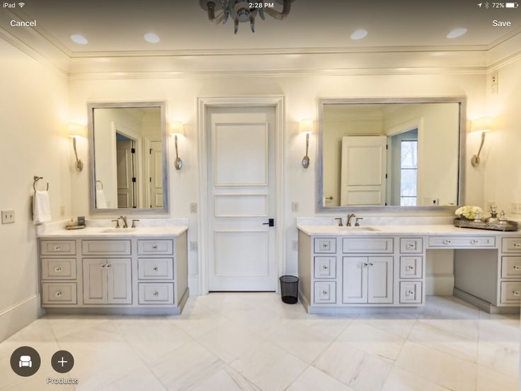 a large bathroom with double sinks and mirrors