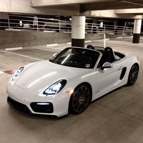 a white sports car parked in a parking garage