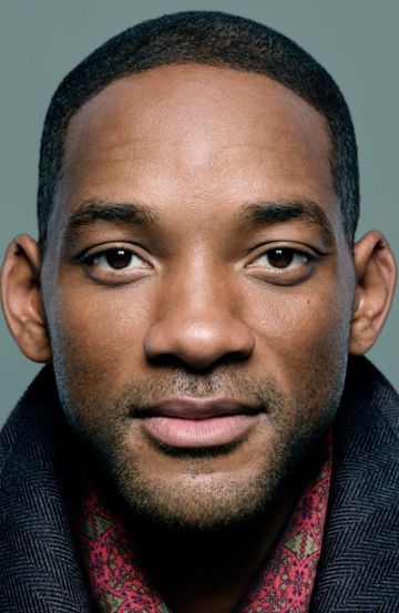 a close up of a person wearing a suit and tie with his eyes wide open