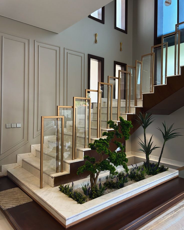 a staircase with plants in the middle next to some windows and doors on either side