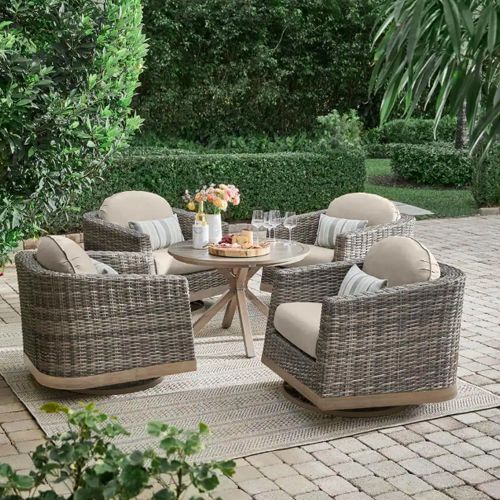 an outdoor patio setting with wicker furniture