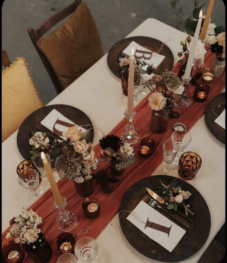 the table is set with candles and flowers