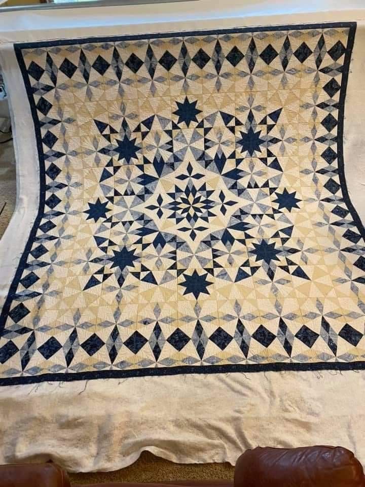 an old quilt on display in a museum