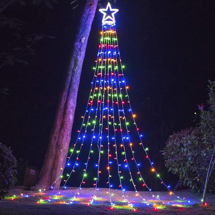 a large christmas tree is lit up with multicolored lights in the shape of a star