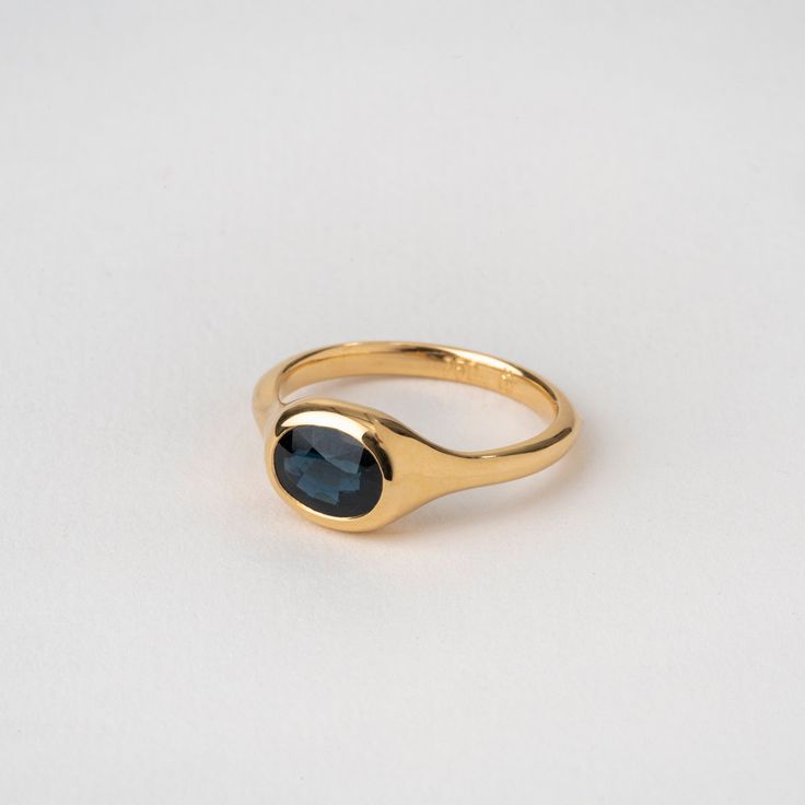 A precious central sapphire in an oval structure ✦ Material ✦ 18k yellow solid gold ✦ Details ✦ Stone: natural (untreated) blue sapphire 1.9 ct Shape: oval faceted or cabochon stone (you can choose) Bezel width: 8 mm Band width: 2.3 mm - Please note Each gemstone can look a little different, there is a range of tones for natural stones. Slight changes in shape and color may occur. All of our items are meticulously made in our studio in HaYogev. Manufacturing time takes 10-20 days. Ring Size This Gold Ring With Colored Stones, Gold Ring Blue Stone, Simple Sapphire Engagement Ring, Timeless Oval Cabochon Sapphire Ring Gift, Oval Sapphire Signet Ring Hallmarked, Oval Sapphire Signet Ring In 14k Gold, Gold Sapphire Ring With Oval Cabochon, Oval Sapphire Ring With Bezel Setting, Oval Sapphire Ring With Polished Finish In 14k Gold