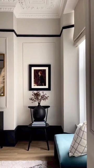 a living room with white walls and black trim