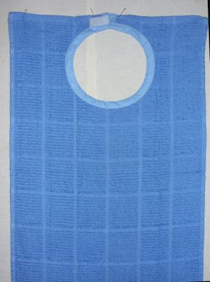 a blue bib hanging on the wall with a hole in it's center