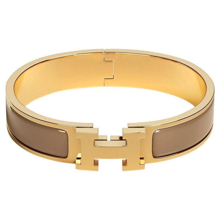 Mightychic offers an Hermes Clic H Bracelet featured in Marron Glace Enamel. Set in Gold plated hardware. Chic, modern and unmistakably Hermes! A hinged band allows the H to swivel and open the bracelet. Comes with pouch and signature Hermes box. NEW or NEVER WORN. final sale SIZE: PM BRACELET MEASURES: DIAMETER 2.25" HEIGHT 0.47" CONDITION: NEW or NEVER WORN Modern Bracelets With Gold-tone Hardware, Luxury Brown Bangle Bracelet, Adjustable Gold Bracelets With Palladium Hardware, Adjustable Gold Bracelet With Palladium Hardware, Luxury Beige Jewelry For Formal Occasions, Hermes Clic H Bracelet, Gold Cuff Bracelets, Hermes Jewelry Bracelet, Hermes Bangle