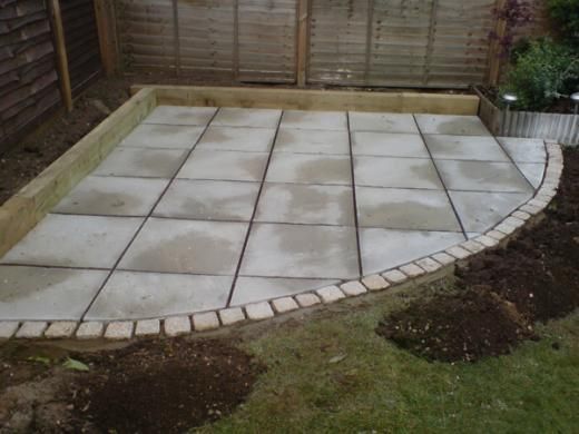 a concrete patio being built in a back yard