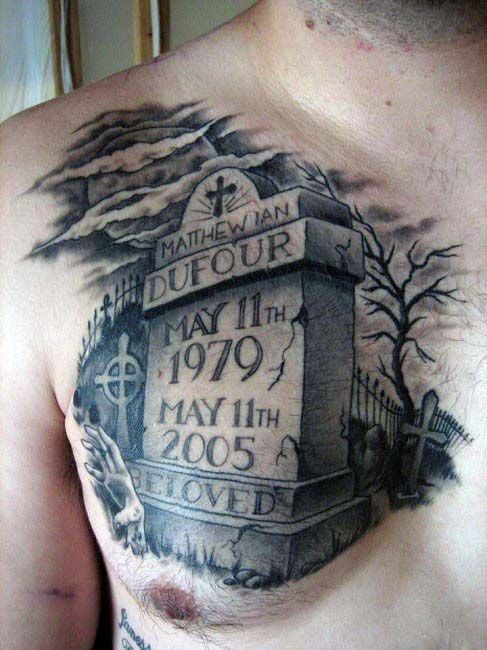 a man's chest with tattoos on it and the name of his grave stone