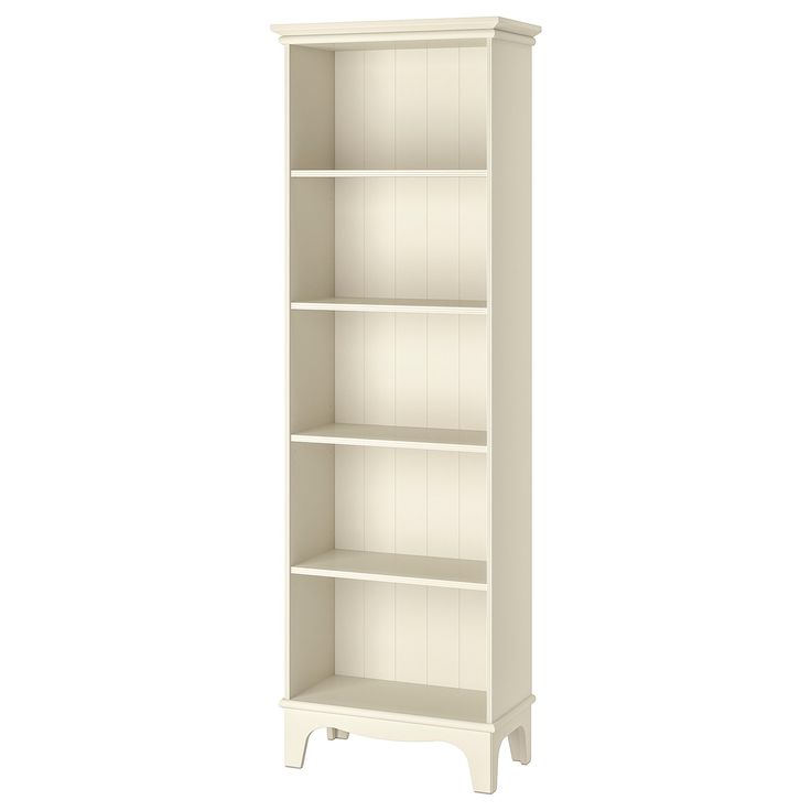 a tall white bookcase with four shelves