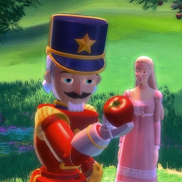 an animated image of a man and woman dressed as nutcrackers, holding apples