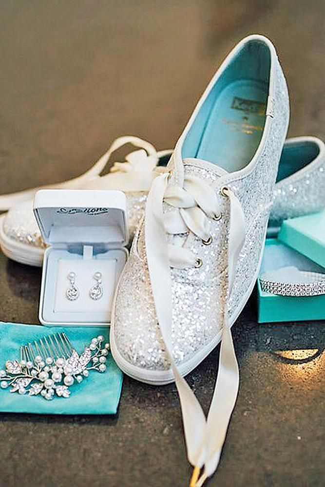 a pair of white shoes sitting on top of a table next to a hair comb