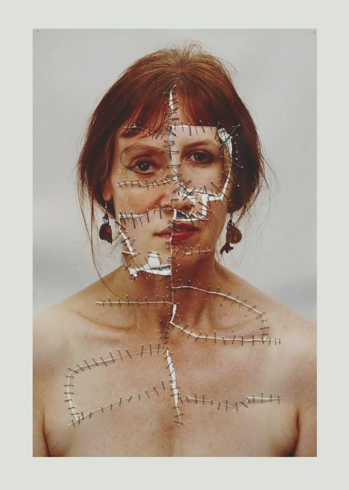 a woman's face is taped to the side with lines drawn across it and she has her eyes closed