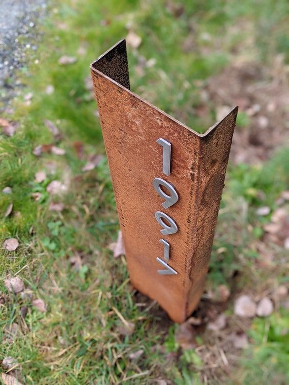 a rusted metal pole with the word love written on it