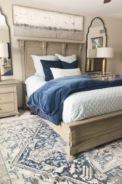 a bedroom with a bed, dresser and mirror in it's centerpieces