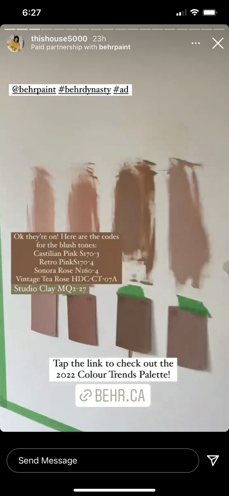 a cell phone with some brown and green paint samples on the wall next to each other