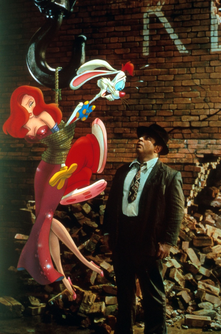 a man standing next to a large balloon sculpture