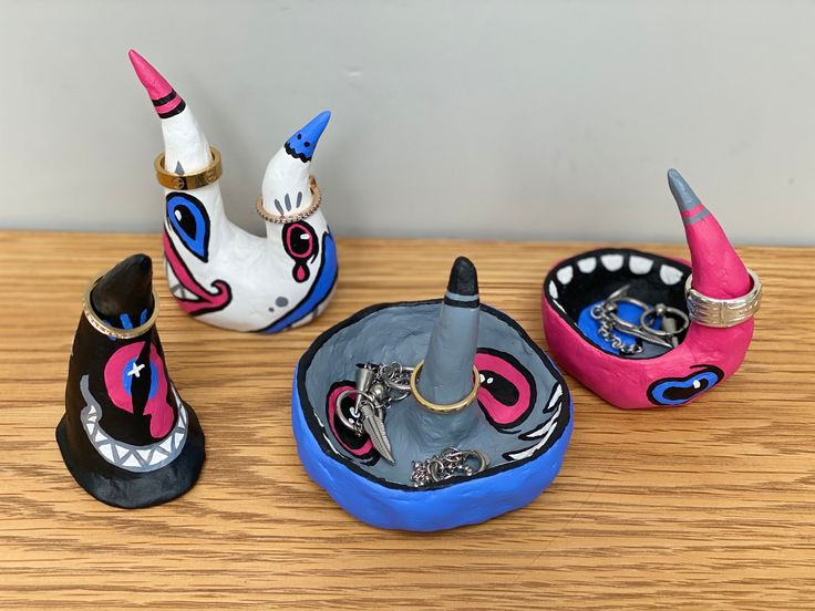 three different shaped objects sitting on top of a wooden table next to an empty container