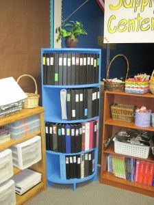 two bookshelves filled with files in front of a sign that says supply center