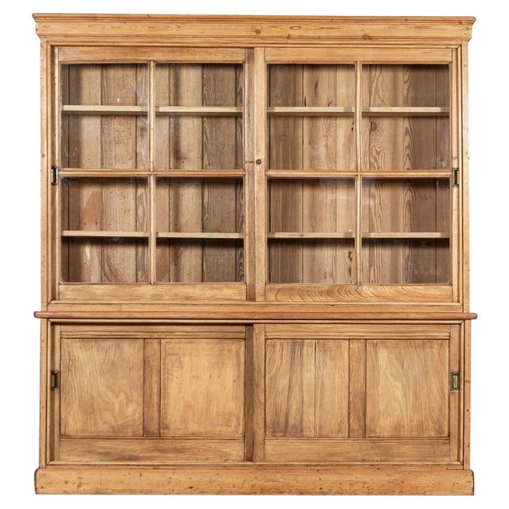 an old wooden bookcase with glass doors