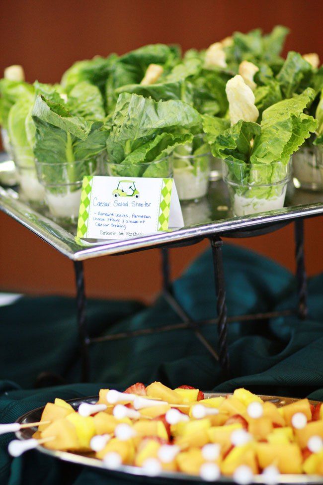 several trays filled with lettuce and fruit