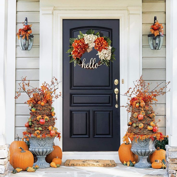 the front door is decorated with pumpkins and other decorations