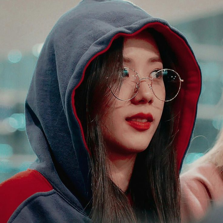 a woman wearing glasses and a hoodie