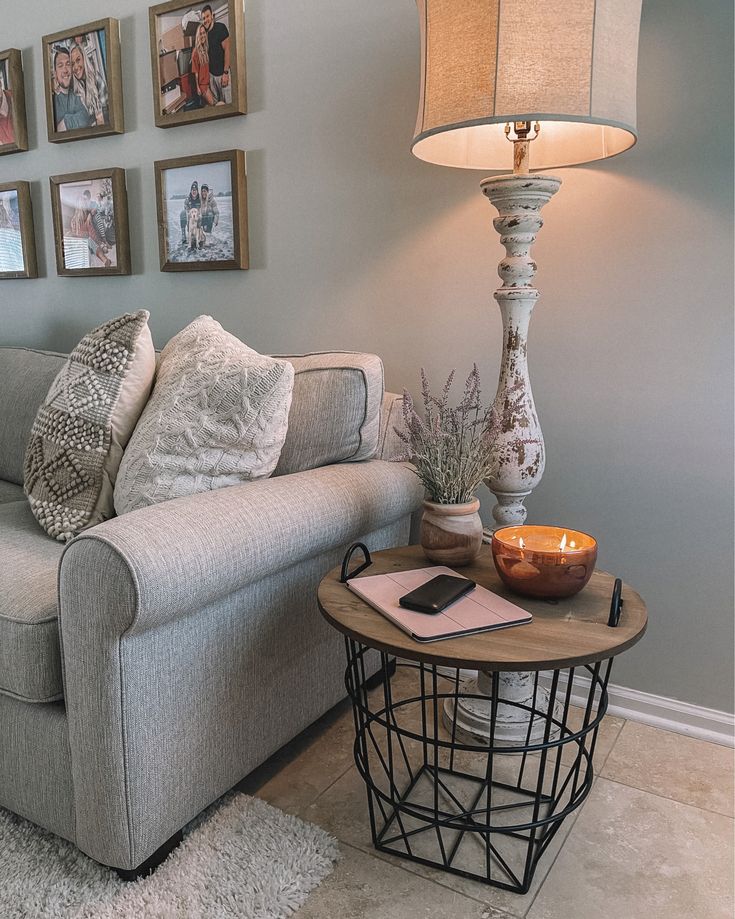 a living room filled with furniture and pictures on the wall next to a coffee table