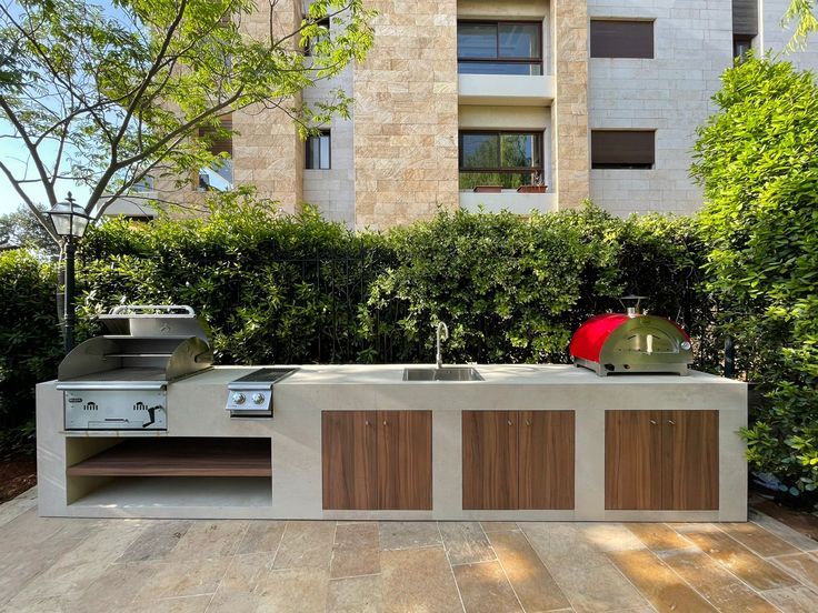 an outdoor kitchen in the middle of a courtyard