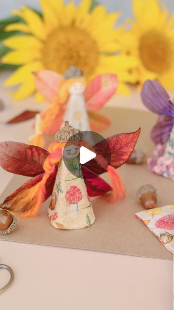 an angel figurine sitting on top of a table next to flowers and other decorations