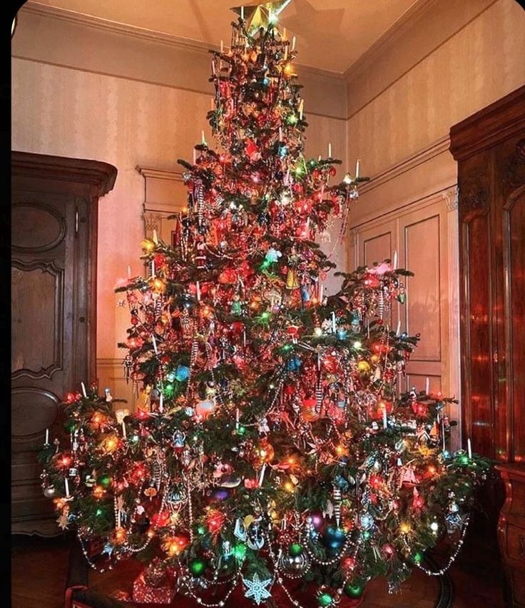 a brightly colored christmas tree in a room