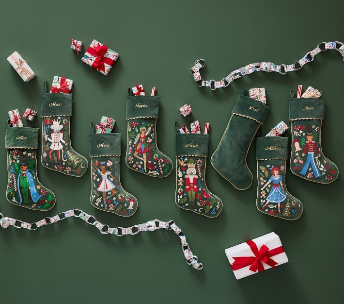 christmas stockings and presents laid out on a green surface