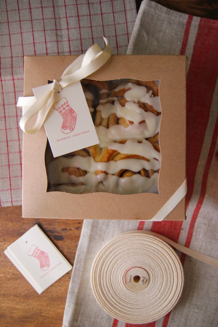 a box filled with pastries sitting on top of a table next to a piece of paper