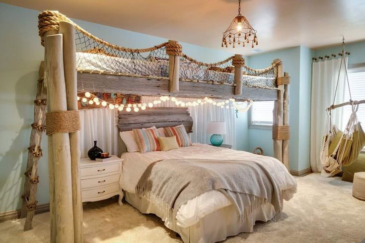 a bedroom with a bed, chair and hammock hanging from the ceiling in it