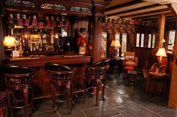 a bar with stools and tables in a room