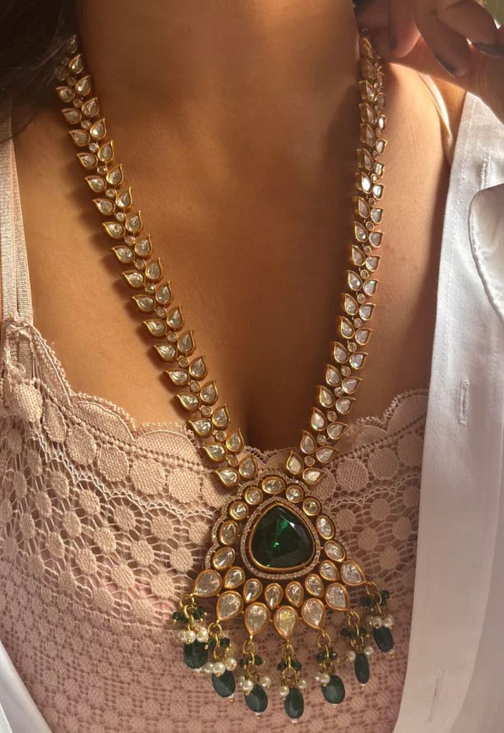 Sabyasachi inspired long Kundan Pendant Necklace With Emerald Green Stone Center Stone  with earrings  Gold Tone Plated  *Premium Quality Necklace Length- 18 inches aprox and Adjustable with a dori.  Earrings length- 1.5 inches aprox  Earrings Have Pushbacks Earrings are light weight Customized orders takes 3 to 4 weeks, depending on piece requirements.  The Ombre Designs Jewelry pieces can be customized in accordance with your requirement.  Please Email or Whats app on : +91 8448833193 / sonali Green Kundan Necklace, Kundan Haram, Long Kundan Necklace, Indian Jewellery Set, Gold Emerald Necklace, Emerald Green Necklace, Kundan Jewellery Set, Sabyasachi Jewellery, Diamond Jewelry Set