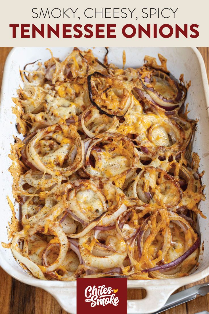 a casserole dish with onions and cheese on it, in a white baking dish