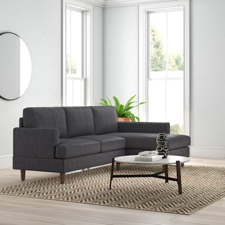 a living room with a gray couch and coffee table